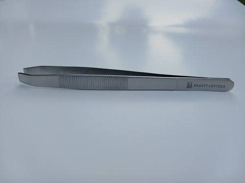 Beauty Lofters big slant stainless steel eyebrow tweezer, angled view