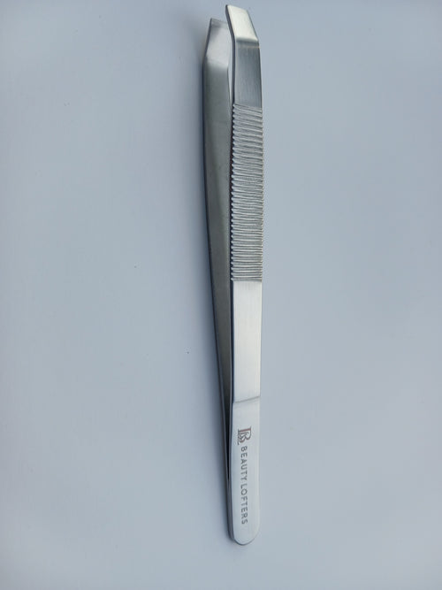 Beauty Lofters slant eyebrow tweezer with line-textured grip